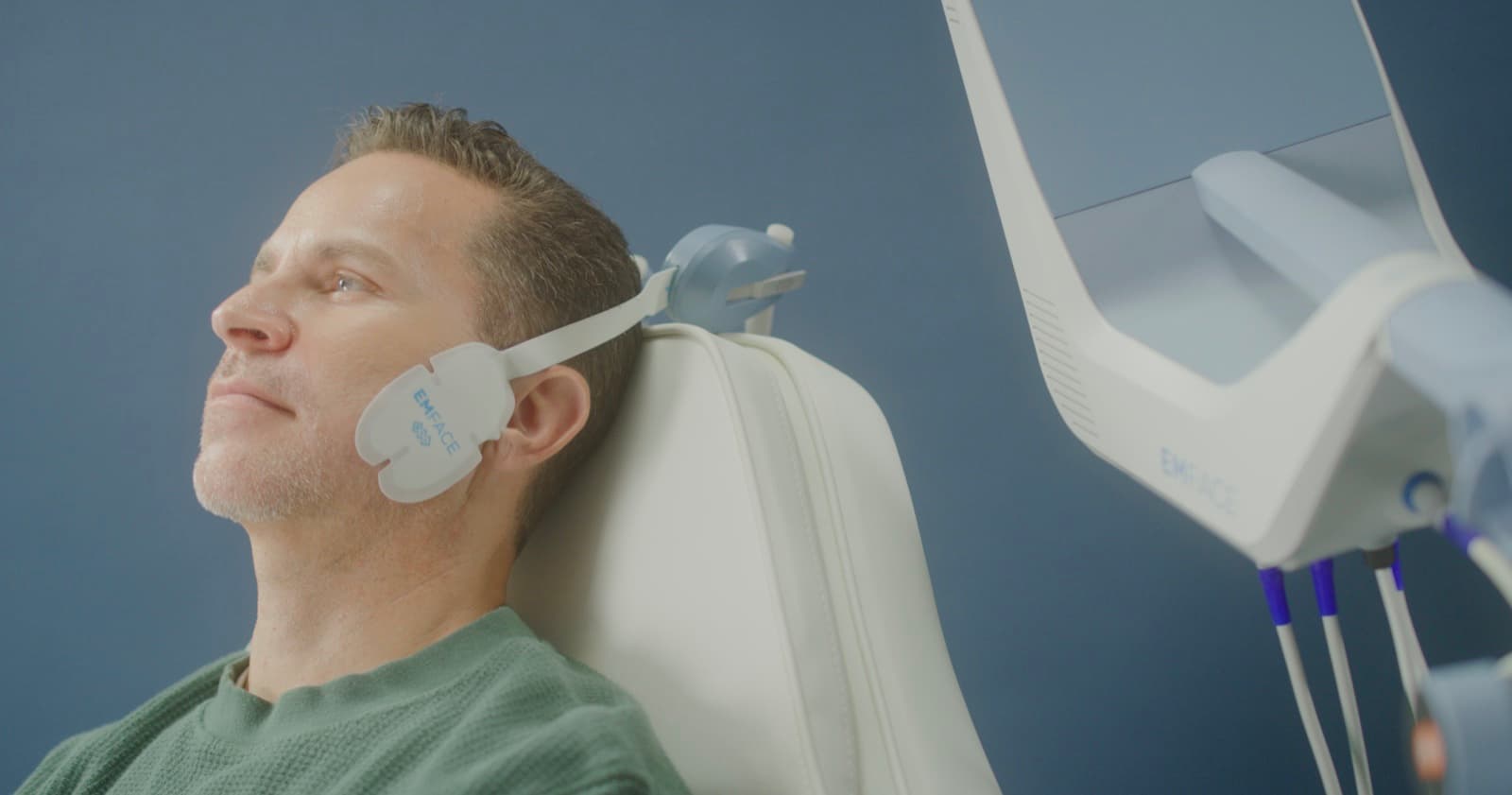 Male patient mid-EMFACE® session — full-face plan