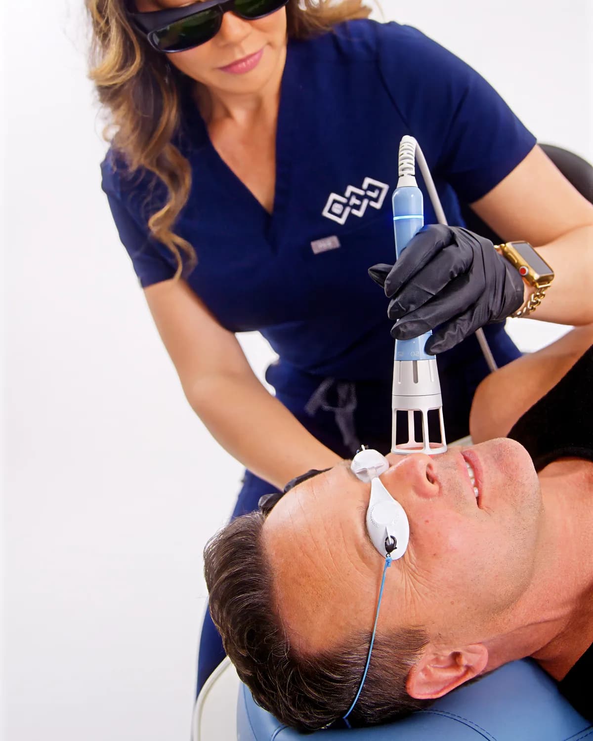 Emvital® treatment over the jaw at Smiles by Goh — patient relaxed, eyes shielded