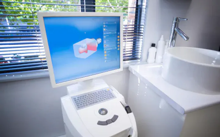 A chairside design station at Smiles by Goh with a restoration being shaped on screen